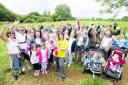 Walkers who turned out at Shotover Country Park to raise money for Charlotte Nott, centre, being held by her mother Jenny Daniels