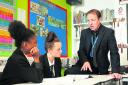 Headteacher David Brown with pupils Olivia May, left, and Lexie Slater