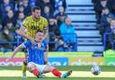 Elliott Moore challenges Portsmouth striker Colby Bishop