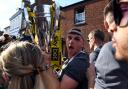 Mark Harris holds the play-off final trophy during the open-top bus tour parade