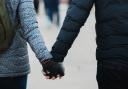 Stock image of a couple holding hands (Unsplash)