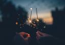 Two people with sparklers on Bonfire Night. Credit: Canva