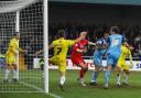 Jack Midson deftly sidefoots home the first of the hat-trick at Torquay
