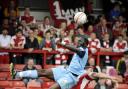 Oxford United defender Jimmy Sangare shows great committment to win a high ball at Accrington on Saturday