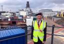 Archie on a rooftop at Scotstoun with the new HMS Glasgow behind