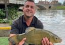 Victor Kmec and the tench he unexpectedly caught in the Thames