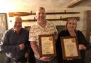 Dave Howse, centre, and Emma Howse receive CAMRA awards