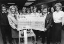 The Duchess of Marlborough, left, receives the cheque from Angela Barney and Alan Winterbourne