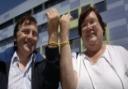 Trevor and Sally Lambert show off their wristbands outside the hospital