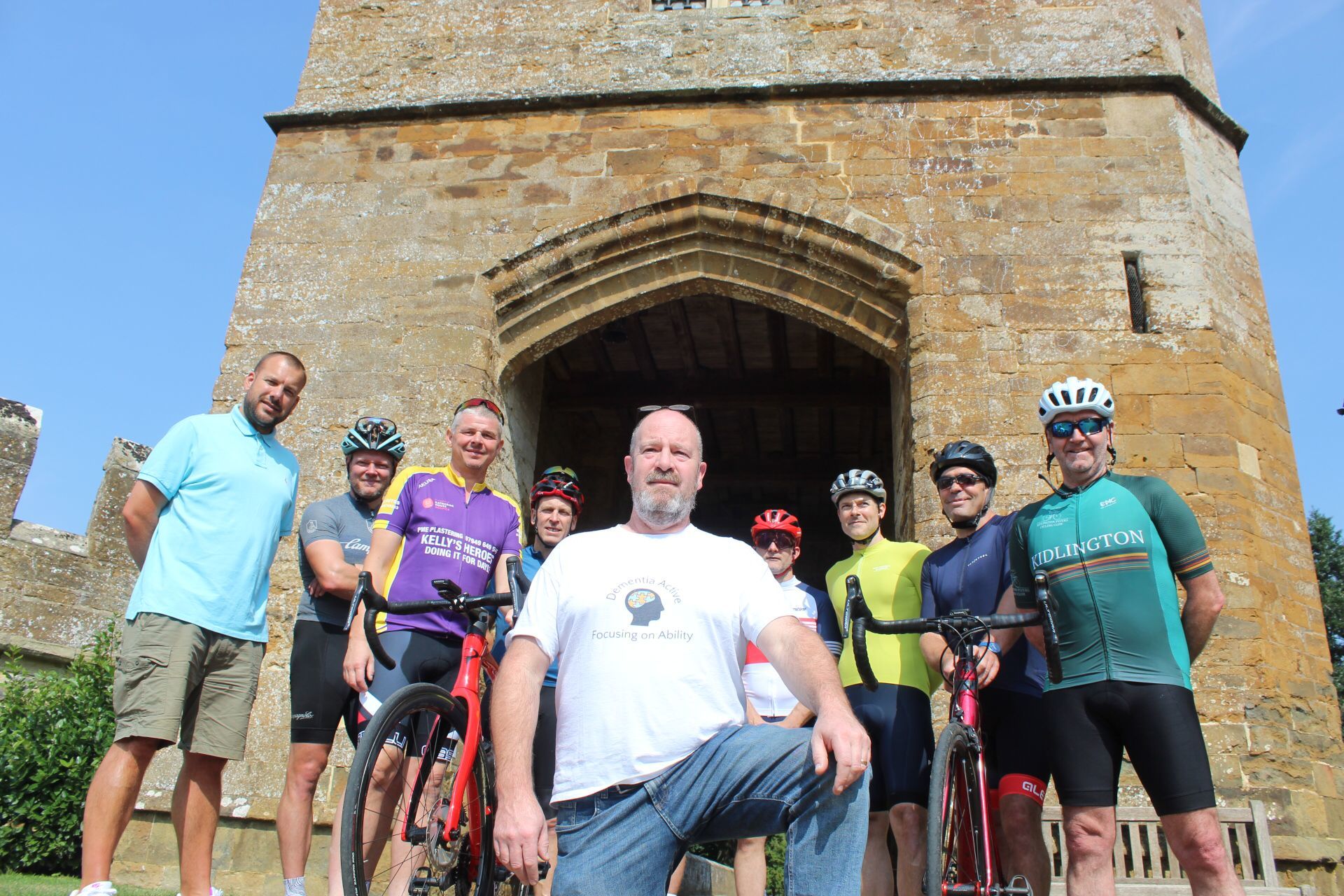 Andy Gill of Dementia Active (centre) with the Kellys Heroes cyclists at Broughton Castle, near Banbury