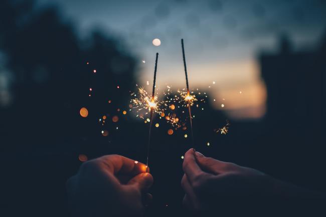 Two people with sparklers on Bonfire Night. Credit: Canva