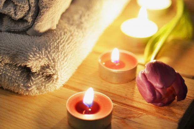 Oxford Mail: A pile of towels, candles and a tulip. Credit: Canva