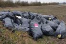 Black bin bags full of insulation material on land at Great Western Park just off Sir Frank Williams Avenue