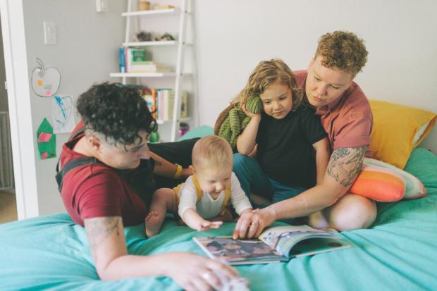 Oxford Mail: A family reading a book together. Credit: Canva