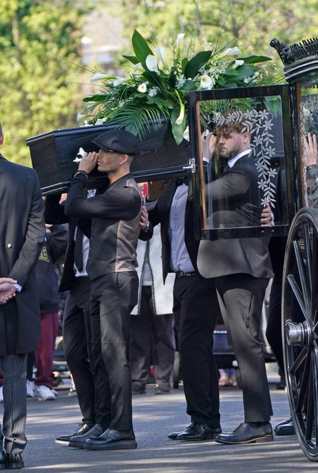 Oxford Mail: Max George and Jay McGuiness of The Wanted carry the coffin at the funeral of their bandmate. (PA)
