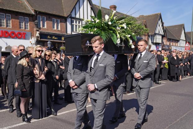 Oxford Mail: The coffin of The Wanted star Tom Parker is carried ahead of his funeral. (PA)