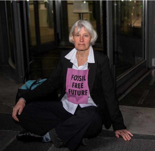Oxford Mail: Teresa Garlake protests outside the main reception entrance to Lloyd’s of London. Picture: Jonathon Vines