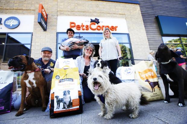 Oxford Mail: Bonnie Cowdrey (centre) with donations for the Chipping Norton Pet Food Bank, upon its launch in June 2020. Picture: Ed Nix