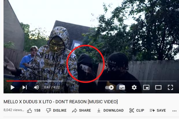 Oxford Mail: Amusan said he may have come into contact with the £50 notes during the filming of a music video, which was posted to YouTube a month before the alleged robbery; circled, the man Amusan picked out as himself Picture: YOUTUBE