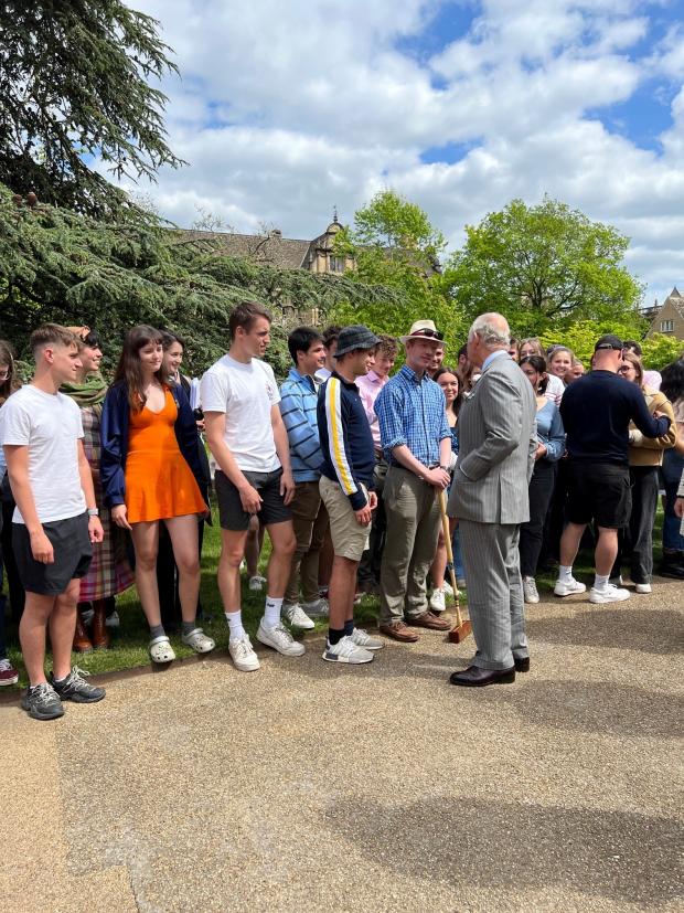 Oxford Mail: Prince Charles meets lecturer Freddie Follows, 23, from Trinity College who got out his croquet stick. Photo by Shosha Adie 
