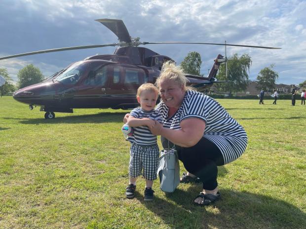 Oxford Mail: Kim Aspel and her son Connor in front of the helicopter.