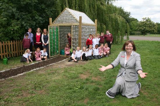 Oxford Mail: Head teacher Judith Tinsley and school rep's and their green house made from plastic bottles in June 2011