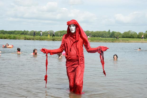 Oxford Mail: Red Rebel stands in stark contrast to swimmers enjoying the river at Port Meadow. Photo by Rory Carnegie 