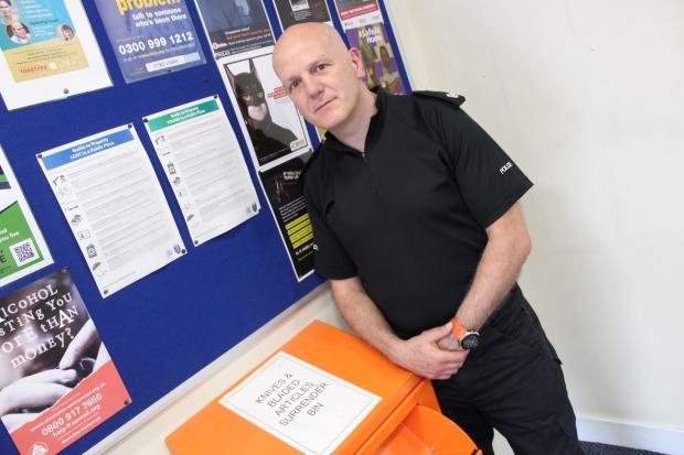 Oxford Mail: Supt Bruce Riddell with a knife amnesty bin at St Aldates Police Station Picture: TVP