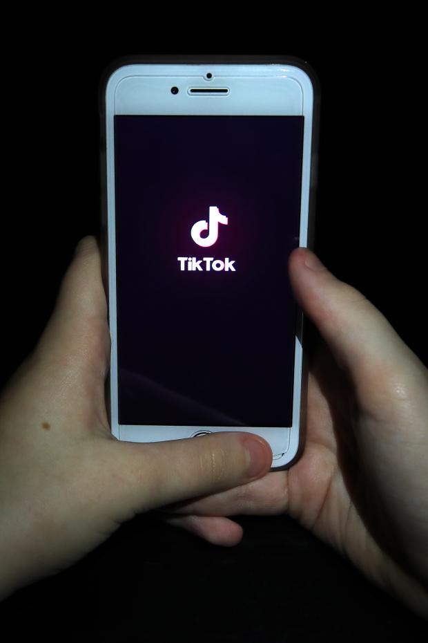 Oxford Mail: A person with TikTok open on their phone. Credit: PA