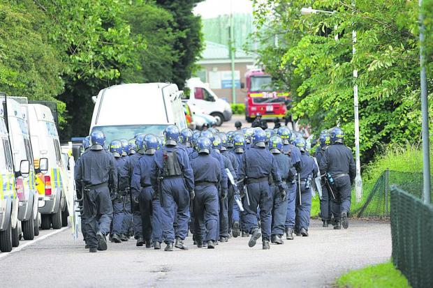 Oxford Mail: Police in protective gear arrive to tackle trouble at Campsfield House detention centre in Kidlington in 2008. Picture Oxford Mail
