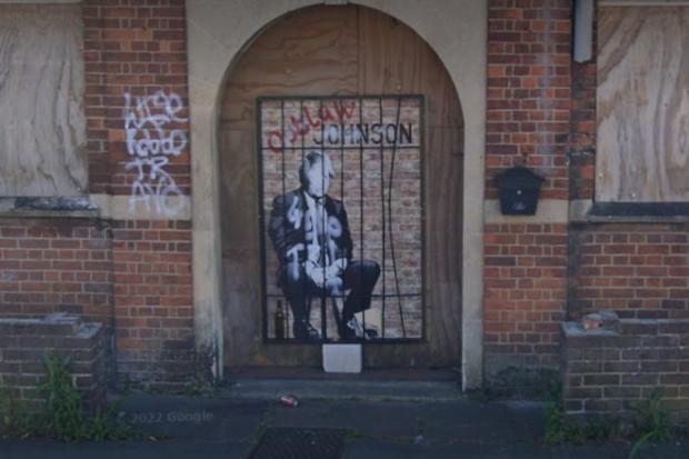 Oxford Mail: The 'Outlaw Johnson' painting daubed in the former entrance to the Cowley Conservative Club, pictured in June 2022 Picture: GOOGLE