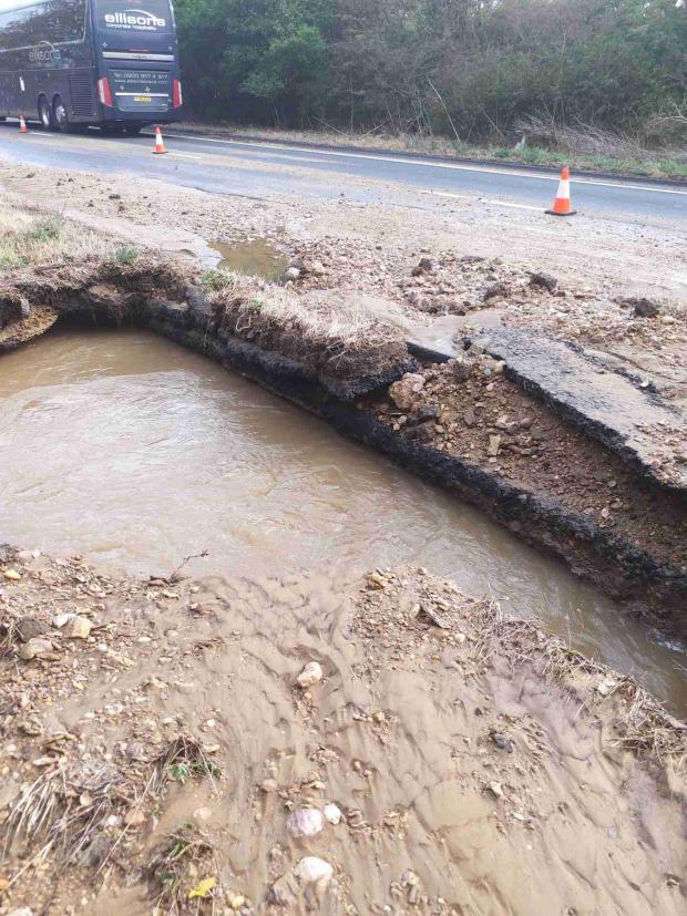 Oxford Mail: A huge sinkhole opened up along the road. Picture: Thames Water