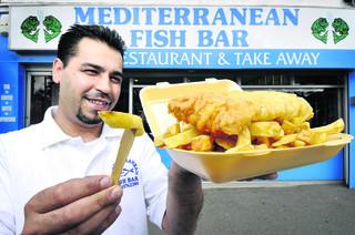 Manager of the Mediterranean Fish Bar, Kemal Koc, is ready to serve again.