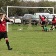 Josh Harper slides in to score Saxton Rovers Res opening goal, much to the disappointment of the Watlington players