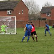 Berinsfield’s Charlie Lee (No 11) curls home a 25-yarder to open the scoring for Berinsfield