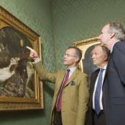 Curator Colin Harrison, left, shows the Millais painting of Ruskin to Ashmolean Museum director Christopher Brown, centre, and Hedley Swain, of Arts Council England in 2013. Picture: Antony Moore