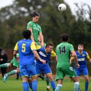 Dan Matsuzaka climbs high above the Royal Wootton Bassett Town defence to head in Oxford City’s equaliser   Picture: Mike Allen