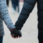 Stock image of a couple holding hands (Unsplash)