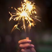 A person holding a lit sparkler for Bonfire night. Credit: Canva