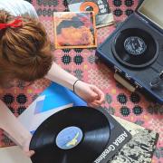 Photo of a music lover listening to a record player. Photo via Natasha Meek/Newsquest.