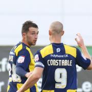 Josh Payne is congratulated by Oxford skipper James Constable after his superb free-kick on Saturday