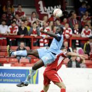 Oxford United defender Jimmy Sangare shows great committment to win a high ball at Accrington on Saturday