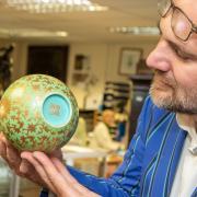 Charles Hanson examines a Chinese Qianlong vase.
