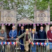 Martin Spurrier, centre, and villagers put up the royal decorations