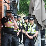 Police look on at the protesters outside the Oxford Union