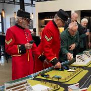 Chelsea Pensioner military veterans enjoying the new Scalextric model at Bicester Heritage