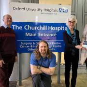 Members of the drama group (L-R) Mike Lacey, Dan Sears and Mary Elizabeth Shewry donate the cheque to Liz Ashworth from Occtopus
