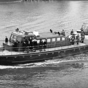 The Havengore, bearing the body of Sir Winston Churchill, travelling along the Thames to Festival Pier