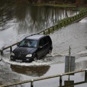 A Mercedes crosses a flooded road in Wallingford