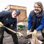 Matt Hudson and Roger Jones shovelling ash into bags at Didcot Railway Centre